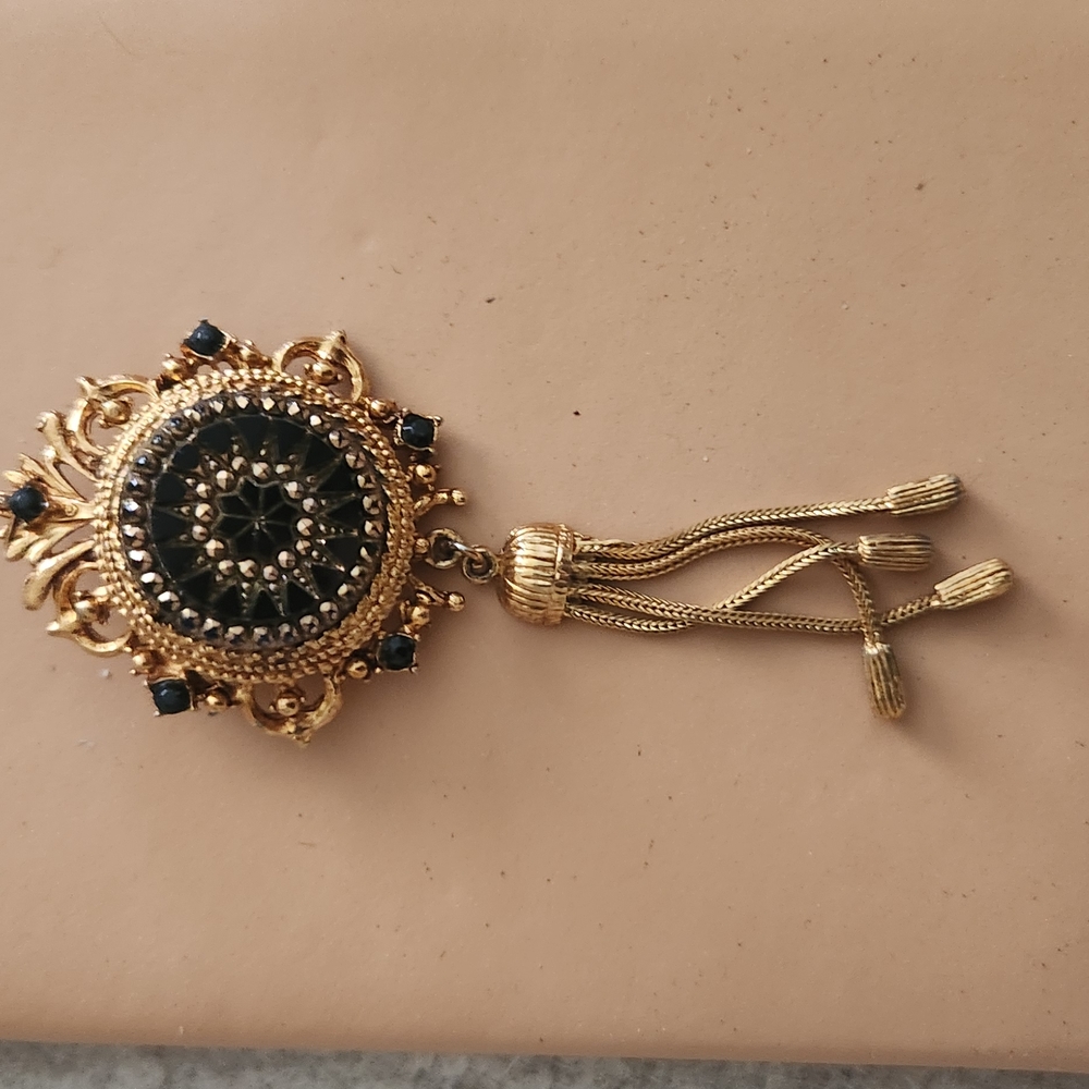 Elegant Gold and Black Brooch